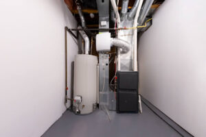A furnace installed next to a water heater in a building.