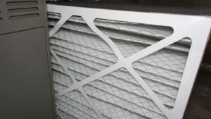 An air filter next to a furnace.