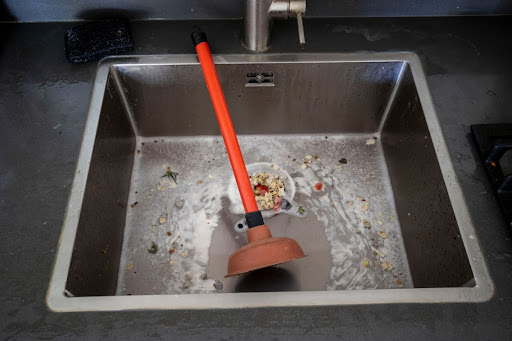 A plunger in a sink.