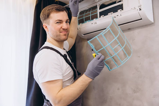 Apollo technician changing dirty filter in AC unit.